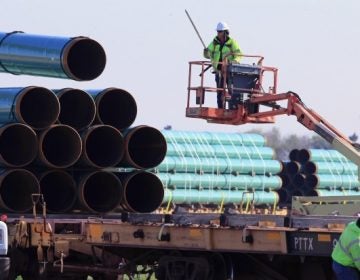 Workers unload pipes at a staging area in Worthing, S.D., for the 1,130-mile Dakota Access Pipeline. A new report says the nation's new natural gas pipeline capacity resulting from a building boom is far more than is needed.